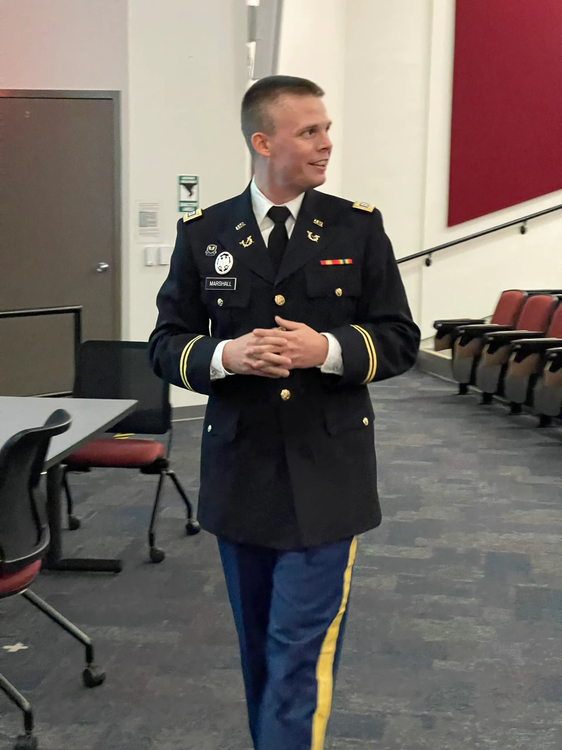 Jason Marshall in Army dress uniform speaking to a room.
